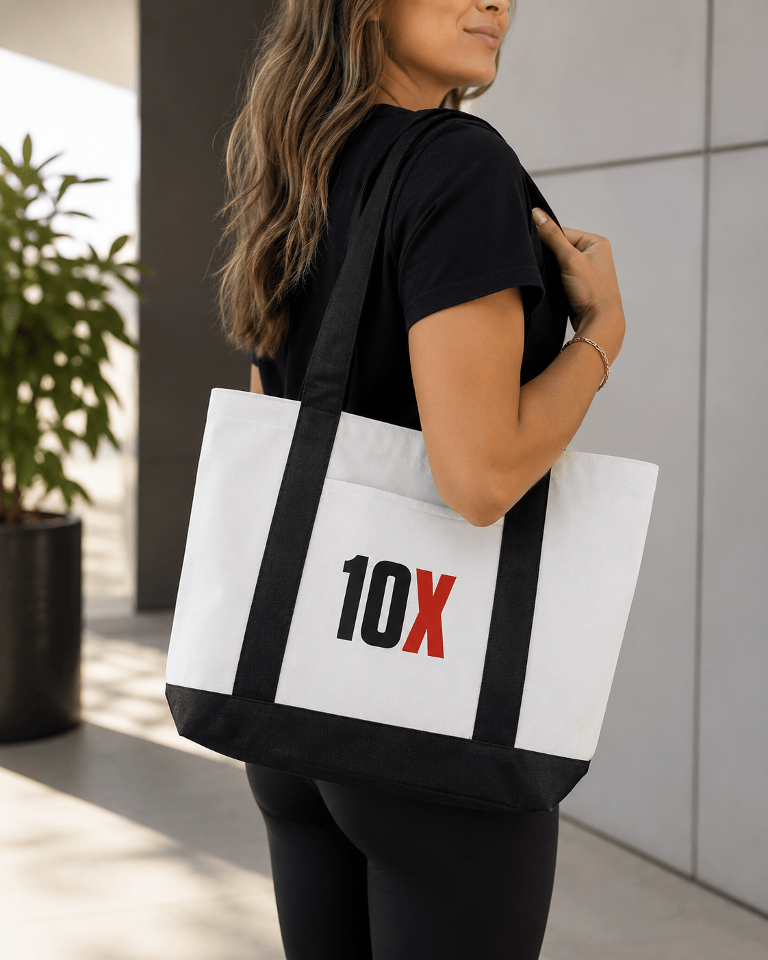 Woman carrying a custom branded 10X tote bag
