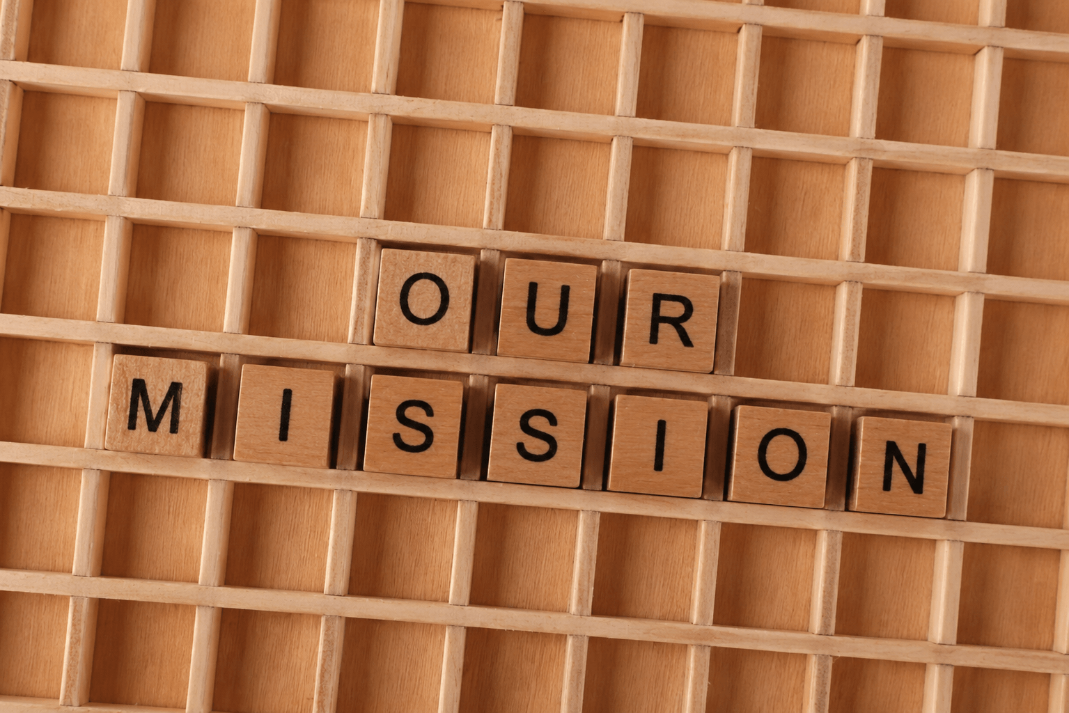 "Our Mission" spelled out in wooden letter tiles