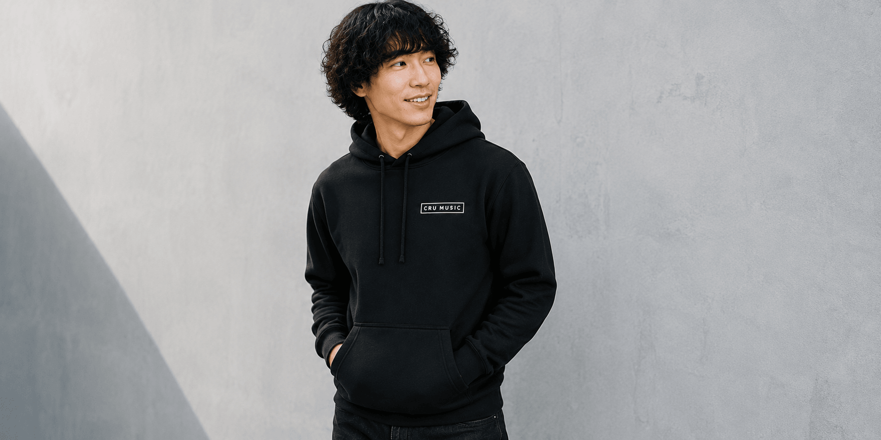 Man wearing an embroidered CRU Music hoodie